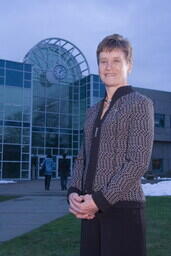 2006 Aunnal Report Photo - Liz Ashton in front of Liz Ashton Campus Center building